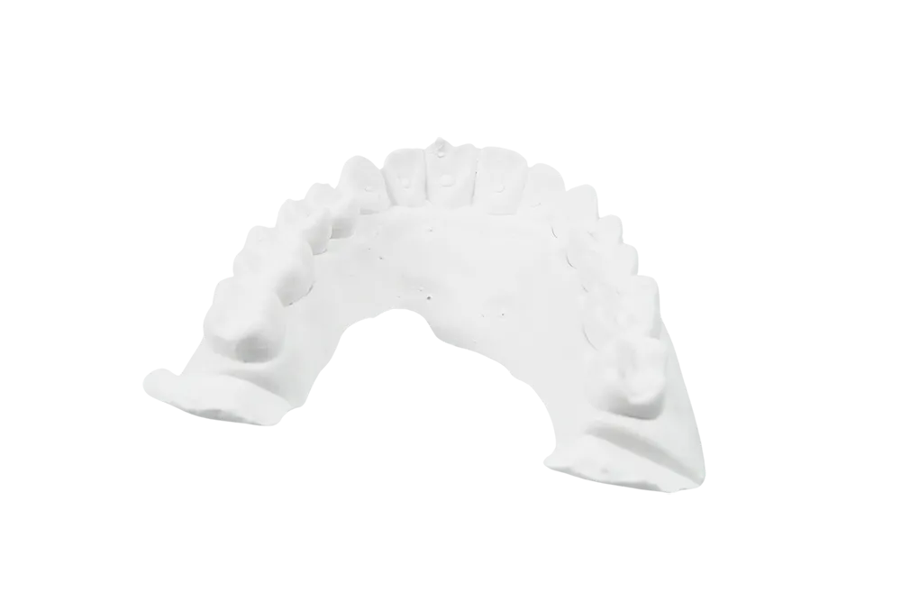 A finished, high-precision master model made from Dental Stone Type IV with a removable die for a single crown.